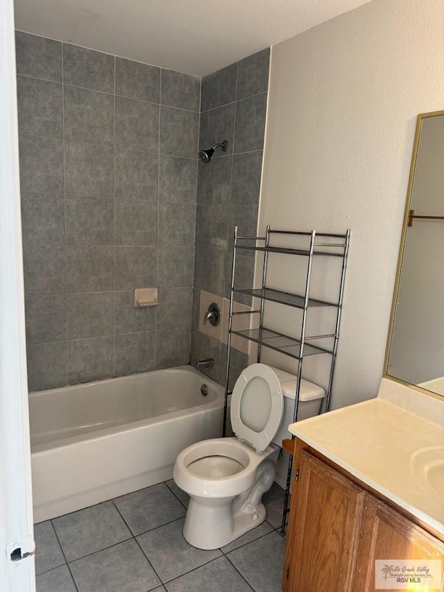 full bathroom featuring tile patterned flooring, vanity, tiled shower / bath combo, and toilet