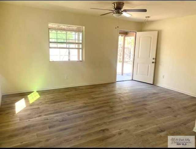 spare room featuring ceiling fan, wood finished floors, and baseboards