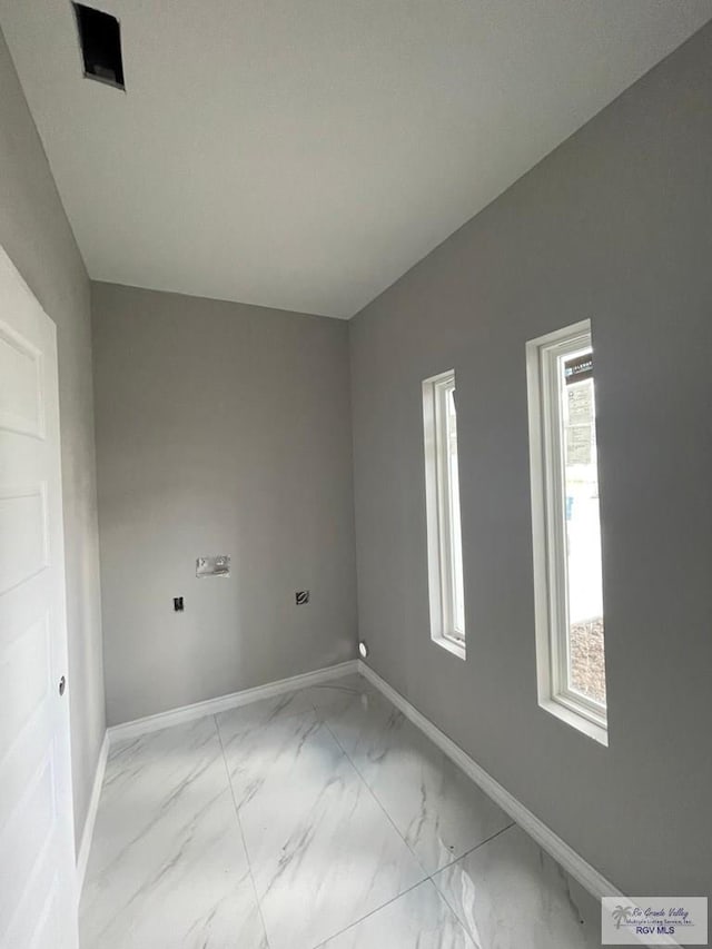 empty room with baseboards and marble finish floor