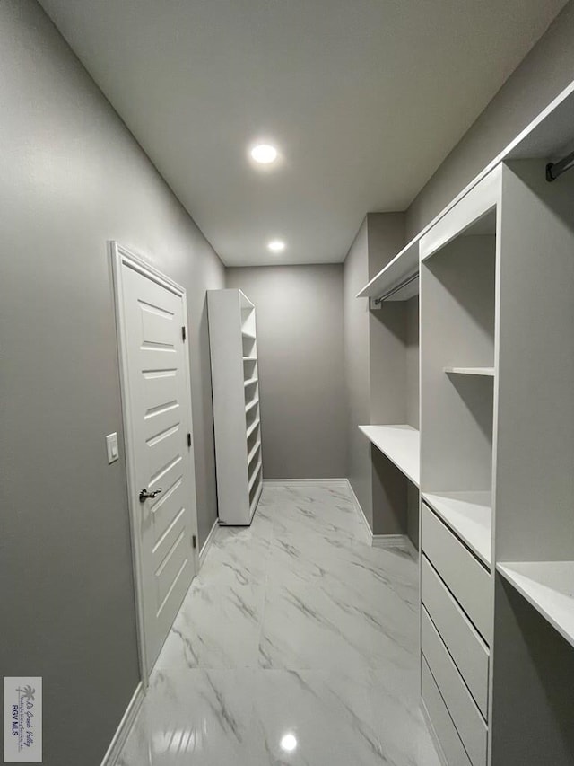 spacious closet featuring marble finish floor