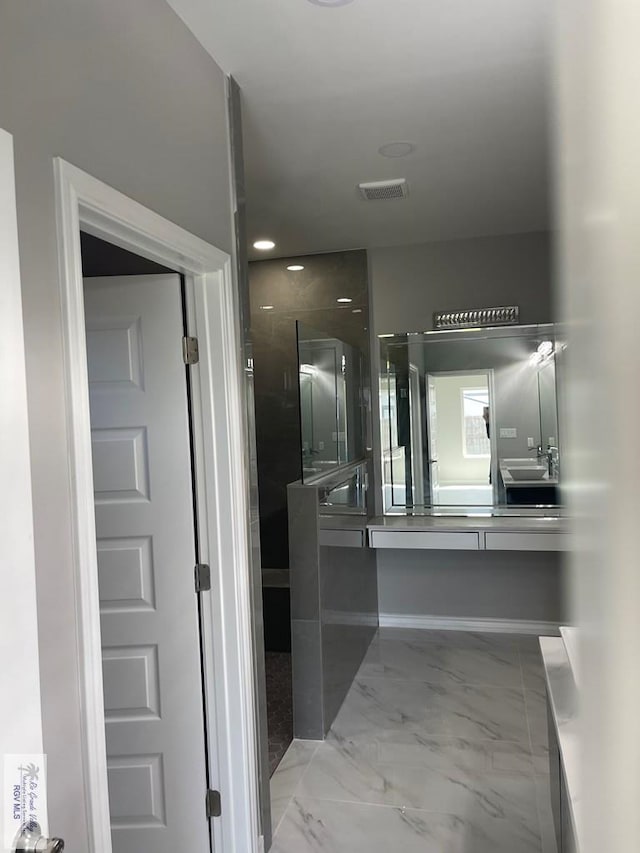 bathroom with vanity, visible vents, marble finish floor, and walk in shower