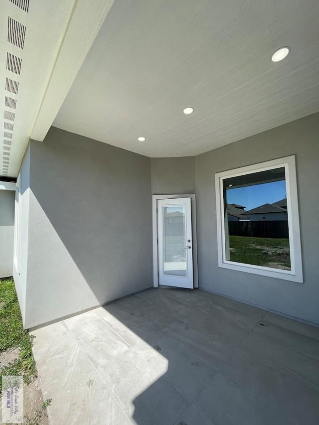 property entrance featuring a patio area and stucco siding