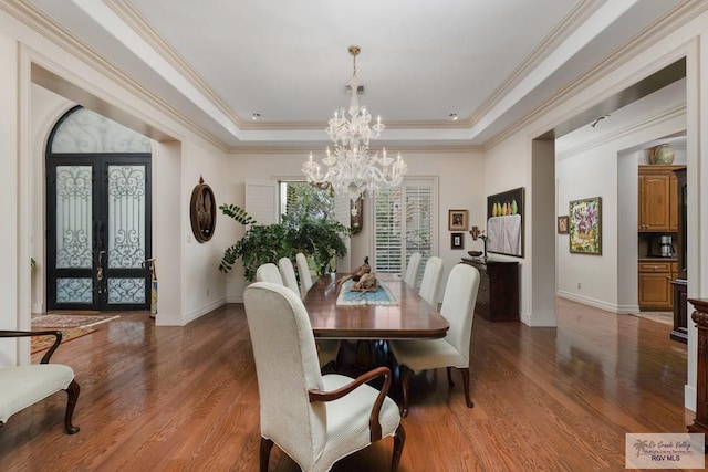 dining area featuring french doors, wood-type flooring, and ornamental molding