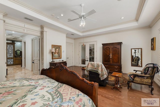 bedroom featuring french doors, light hardwood / wood-style flooring, ceiling fan, and ornamental molding