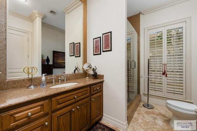 bathroom featuring toilet, vanity, an enclosed shower, and ornamental molding