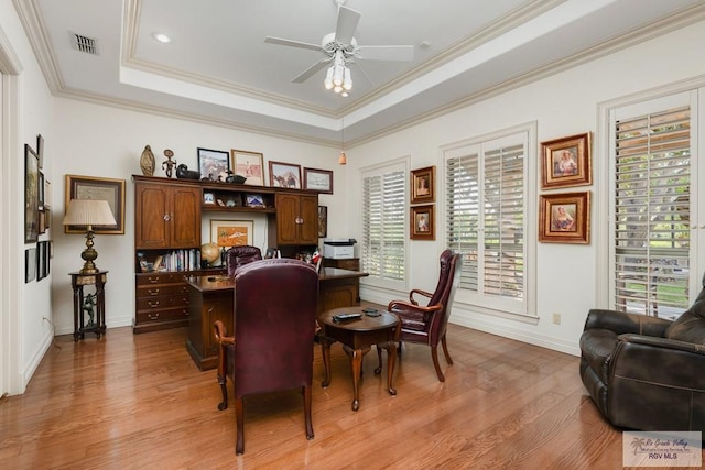 office with a raised ceiling, crown molding, light hardwood / wood-style flooring, and ceiling fan