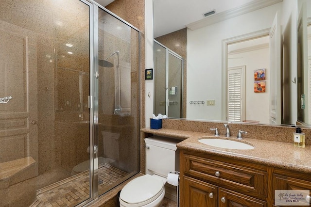 bathroom with vanity, a shower with shower door, and toilet