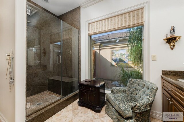 bathroom featuring vanity and an enclosed shower