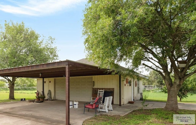 view of parking with a yard and a carport