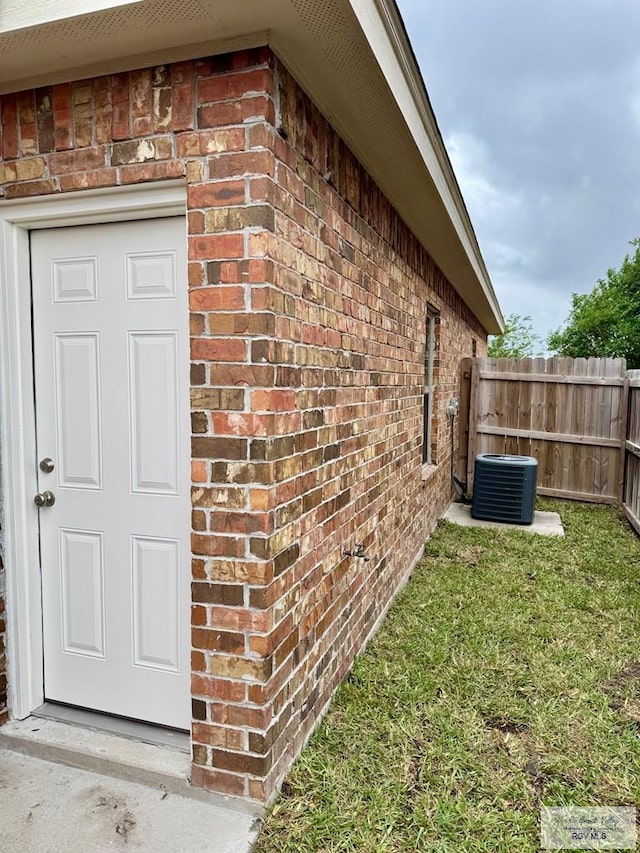 2611 E Eisenhower Ave Unit 50, Alton, TX 78573 - property entrance with brick siding and central AC unit