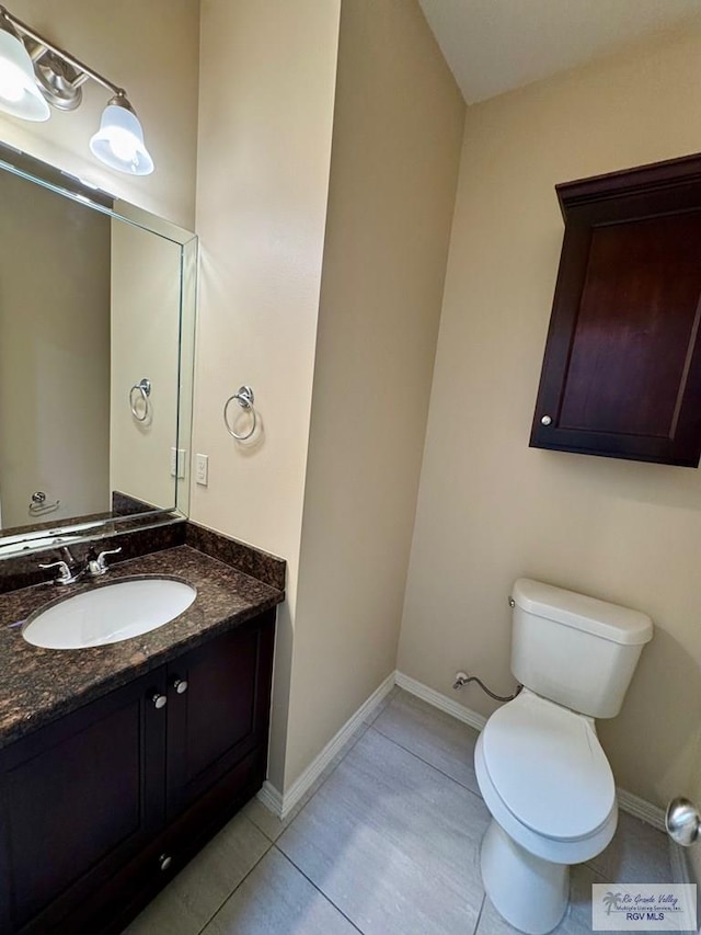 2611 E Eisenhower Ave Unit 50, Alton, TX 78573 - bathroom featuring vanity, toilet, tile patterned floors, and baseboards