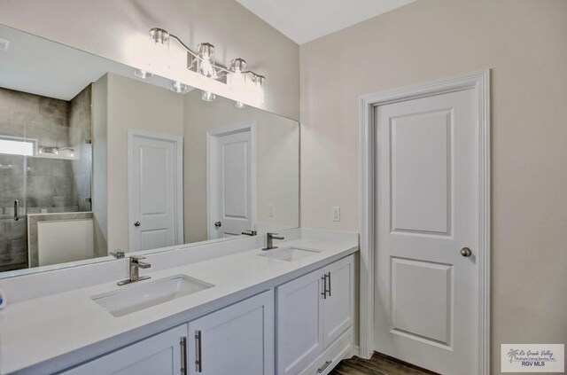 1829 Stirrup Cir, San Benito, TX 78586 - bathroom with a stall shower and double vanity