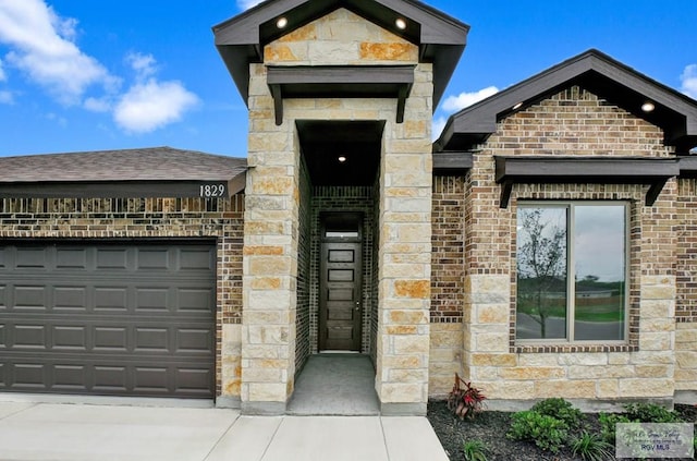 1829 Stirrup Cir, San Benito, TX 78586 - property entrance with brick siding, stone siding, and a garage