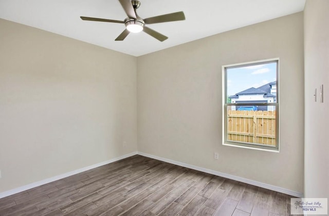 1829 Stirrup Cir, San Benito, TX 78586 - spare room featuring wood finished floors, baseboards, and ceiling fan