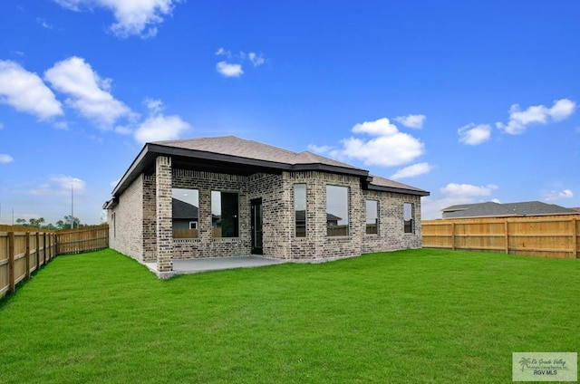 1829 Stirrup Cir, San Benito, TX 78586 - rear view of house featuring brick siding and a patio area