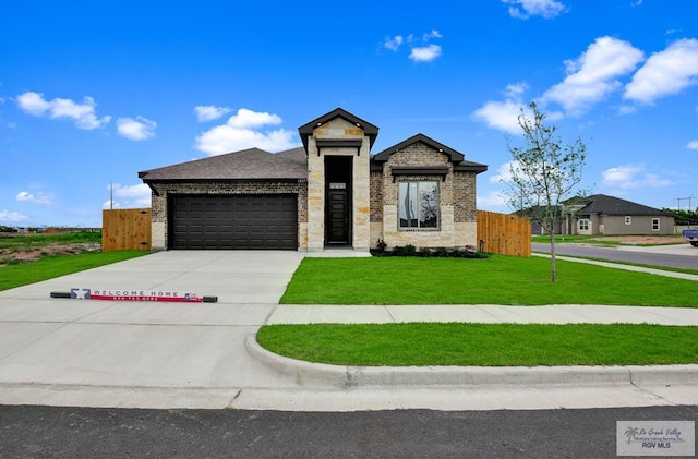 1829 Stirrup Cir, San Benito, TX 78586 - contemporary home with an attached garage, driveway, stone siding, and brick siding