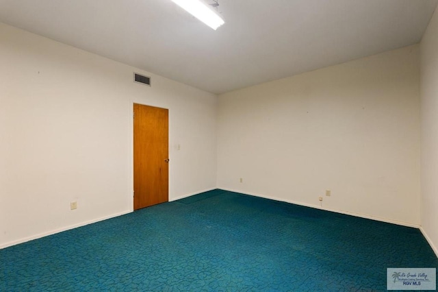 unfurnished room with baseboards, visible vents, and carpet floors