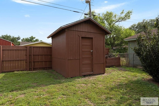 view of shed with a fenced backyard