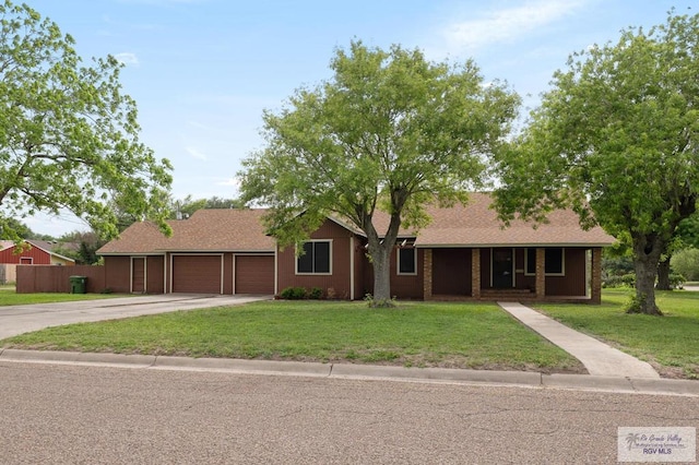 ranch-style house with concrete driveway, a front lawn, covered porch, fence, and a garage