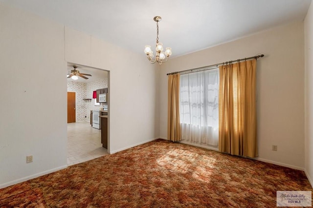 carpeted spare room featuring wallpapered walls, baseboards, and ceiling fan with notable chandelier