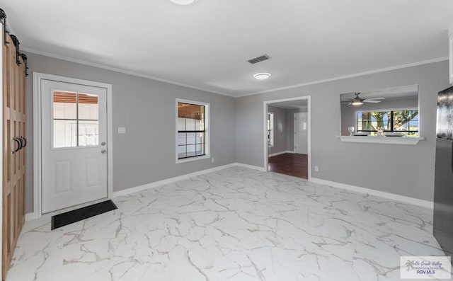 23570 Stuart Place Rd, Harlingen, TX 78552 - entrance foyer featuring a barn door, ornamental molding, baseboards, ceiling fan, and marble finish flooring