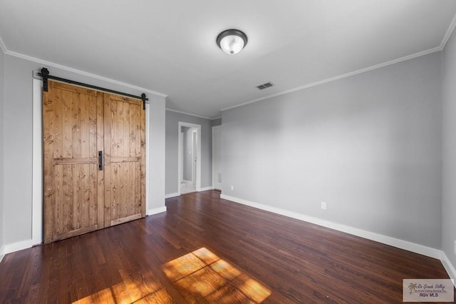 23570 Stuart Place Rd, Harlingen, TX 78552 - unfurnished bedroom with crown molding, dark wood finished floors, baseboards, and a barn door