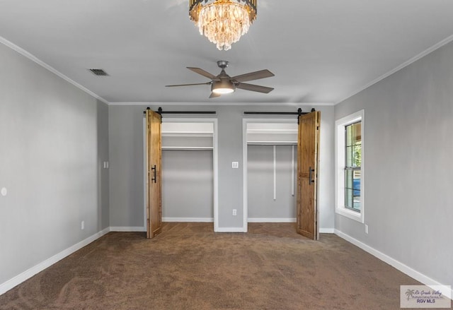 23570 Stuart Place Rd, Harlingen, TX 78552 - unfurnished bedroom featuring two closets, carpet floors, a barn door, and ornamental molding