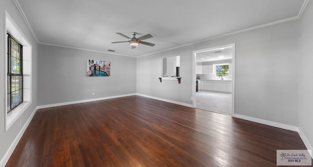 23570 Stuart Place Rd, Harlingen, TX 78552 - spare room with wood finished floors, a ceiling fan, crown molding, and baseboards