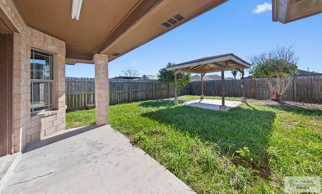 view of yard with a patio area, a fenced backyard, and a gazebo