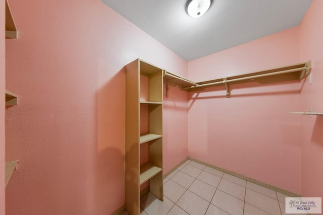 spacious closet featuring light tile patterned floors