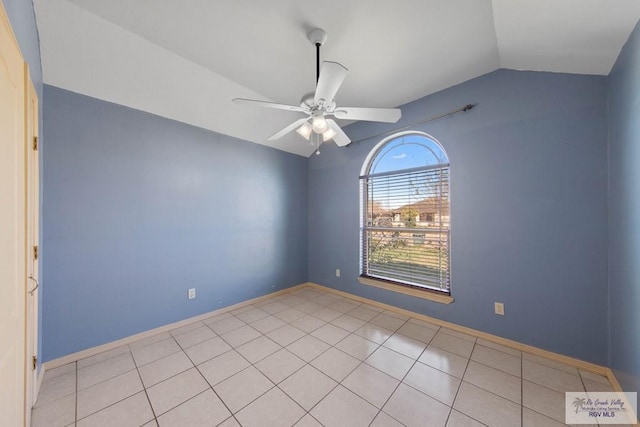 unfurnished room featuring ceiling fan, baseboards, vaulted ceiling, and light tile patterned flooring