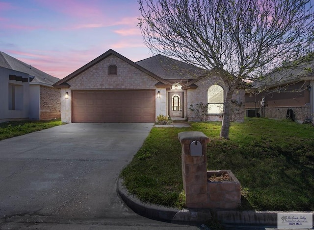 ranch-style home featuring a garage and driveway