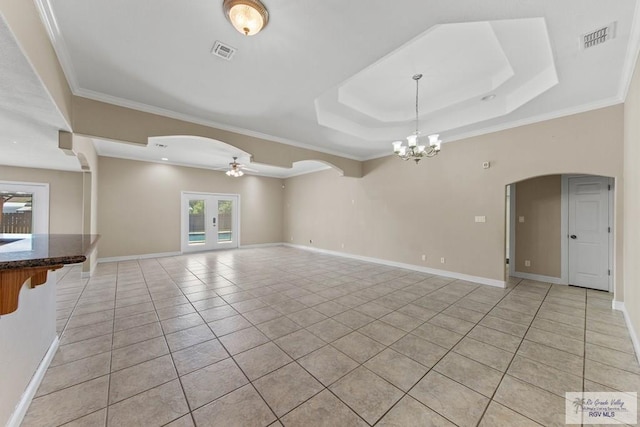 unfurnished living room with french doors, ceiling fan with notable chandelier, light tile patterned floors, and crown molding