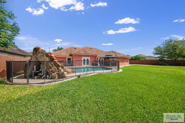 view of yard with a fenced in pool