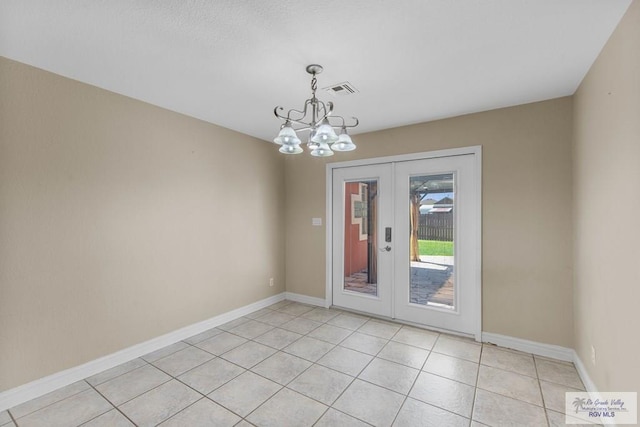 interior space featuring french doors, light tile patterned floors, and a chandelier