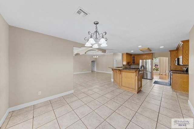 kitchen featuring a chandelier, appliances with stainless steel finishes, decorative light fixtures, and light tile patterned floors