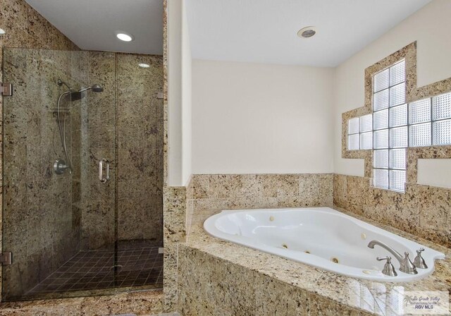 bathroom with shower with separate bathtub