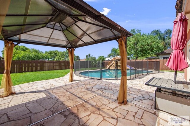 view of pool with a gazebo, a patio area, and a lawn