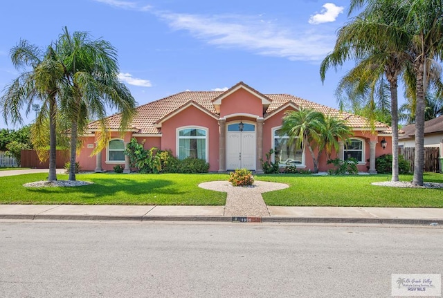 mediterranean / spanish-style house featuring a front yard