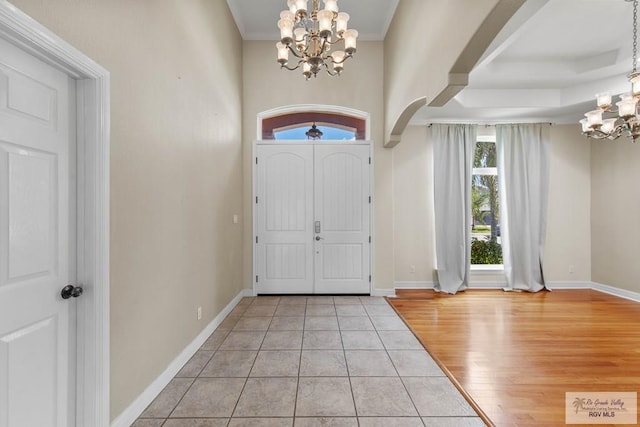 entrance foyer featuring light hardwood / wood-style flooring and a notable chandelier