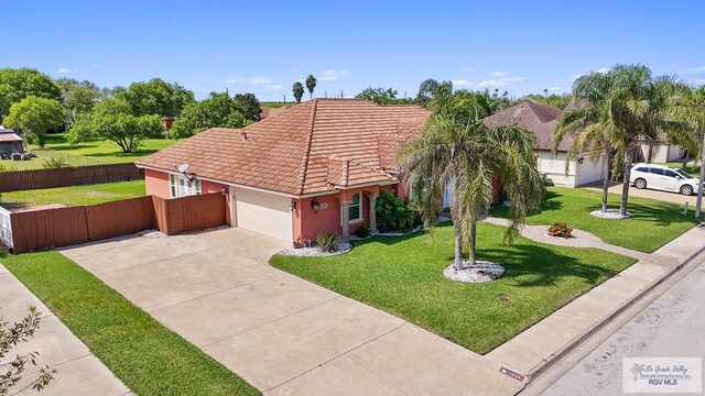 view of front of house with a garage and a front lawn