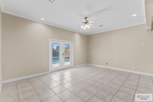 tiled spare room featuring ceiling fan, crown molding, and french doors