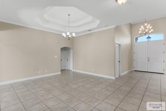 entrance foyer with an inviting chandelier, crown molding, and light tile patterned flooring