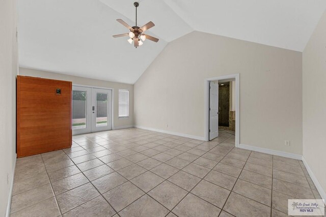 spare room with ceiling fan, french doors, light tile patterned floors, and high vaulted ceiling