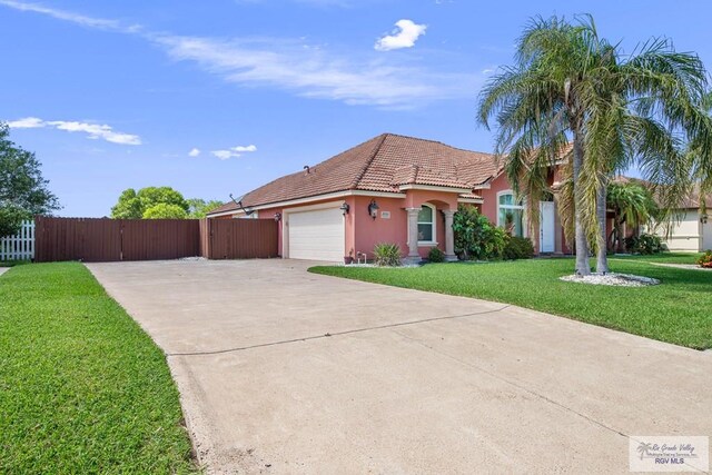 view of front of house with a garage and a front lawn