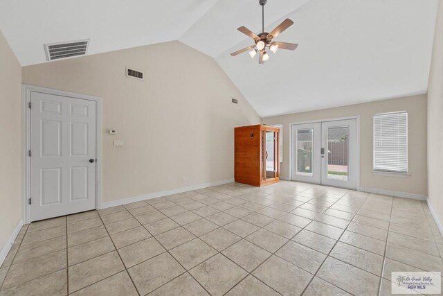 unfurnished living room featuring french doors, high vaulted ceiling, light tile patterned floors, and ceiling fan