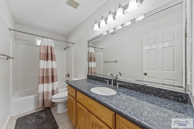 full bathroom with toilet, shower / bath combo, vanity, and tile patterned floors