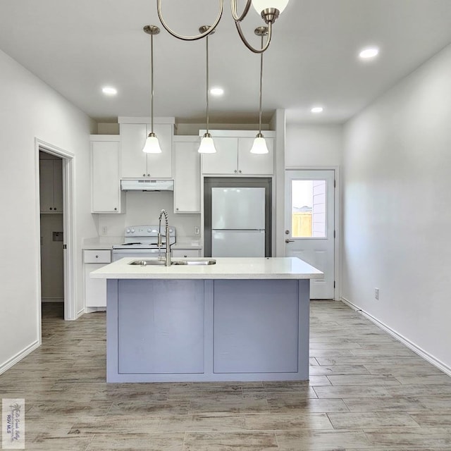 kitchen featuring white appliances, a center island with sink, white cabinetry, and sink