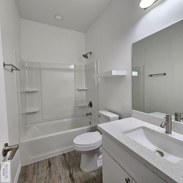 full bathroom featuring hardwood / wood-style flooring, vanity, toilet, and shower / bathing tub combination