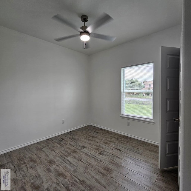 empty room with ceiling fan and dark hardwood / wood-style flooring